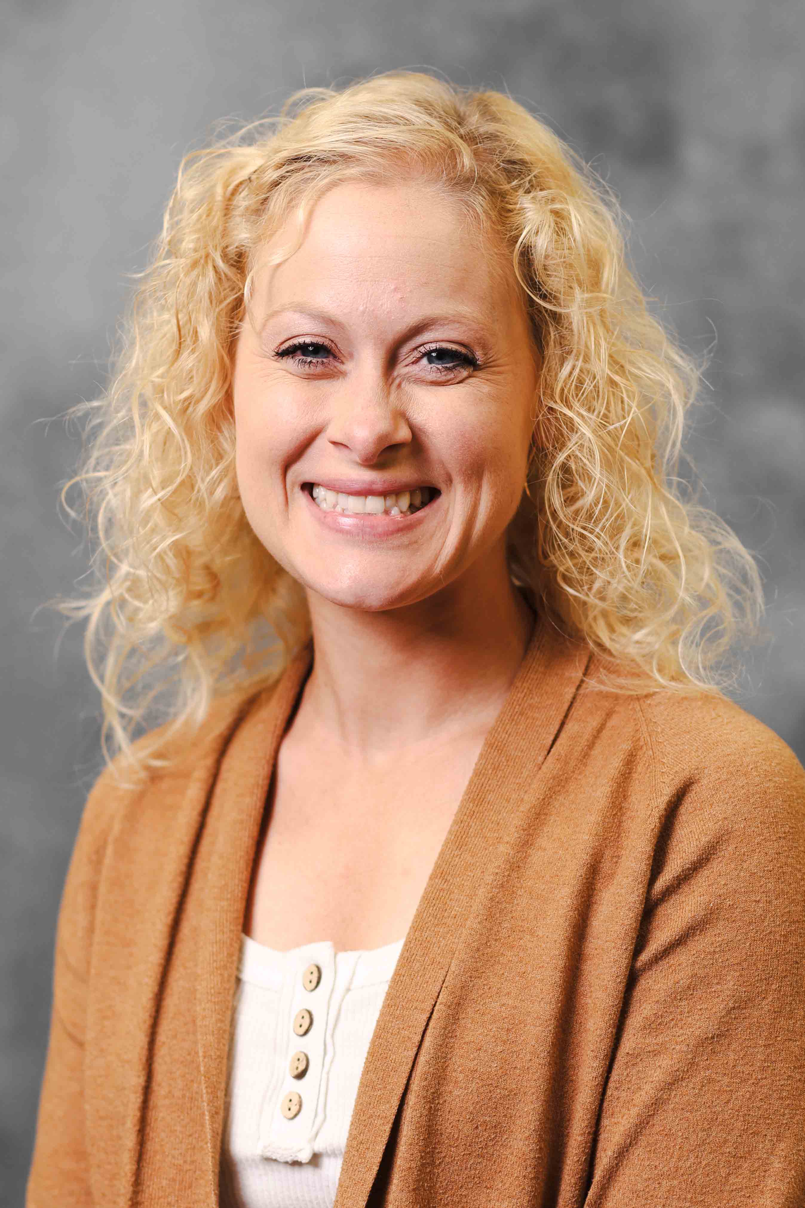 Portrait headshot on gray background of teacher, Mandy Burgess