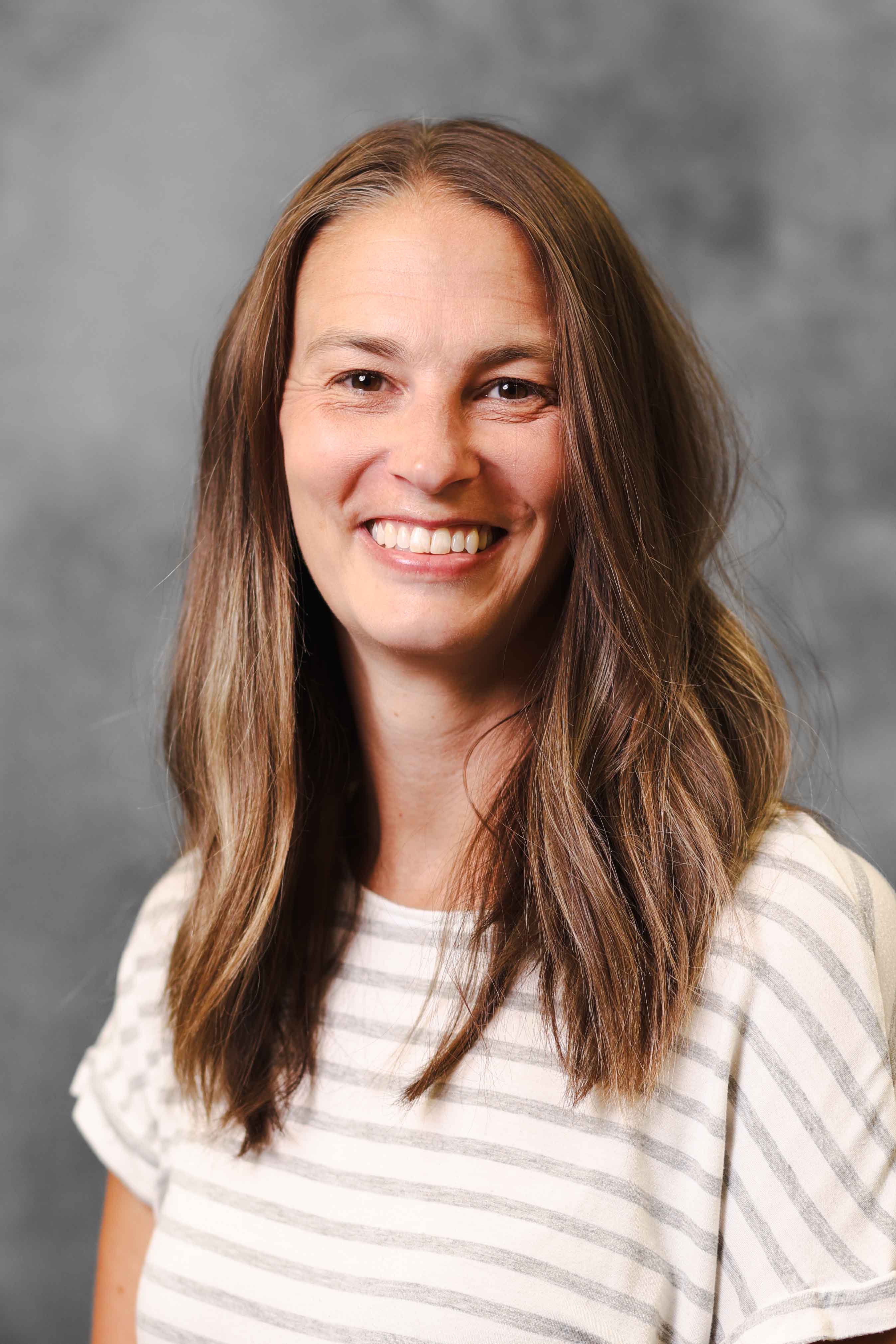 Portrait headshot on gray background of teacher, Alyssa Gordon.