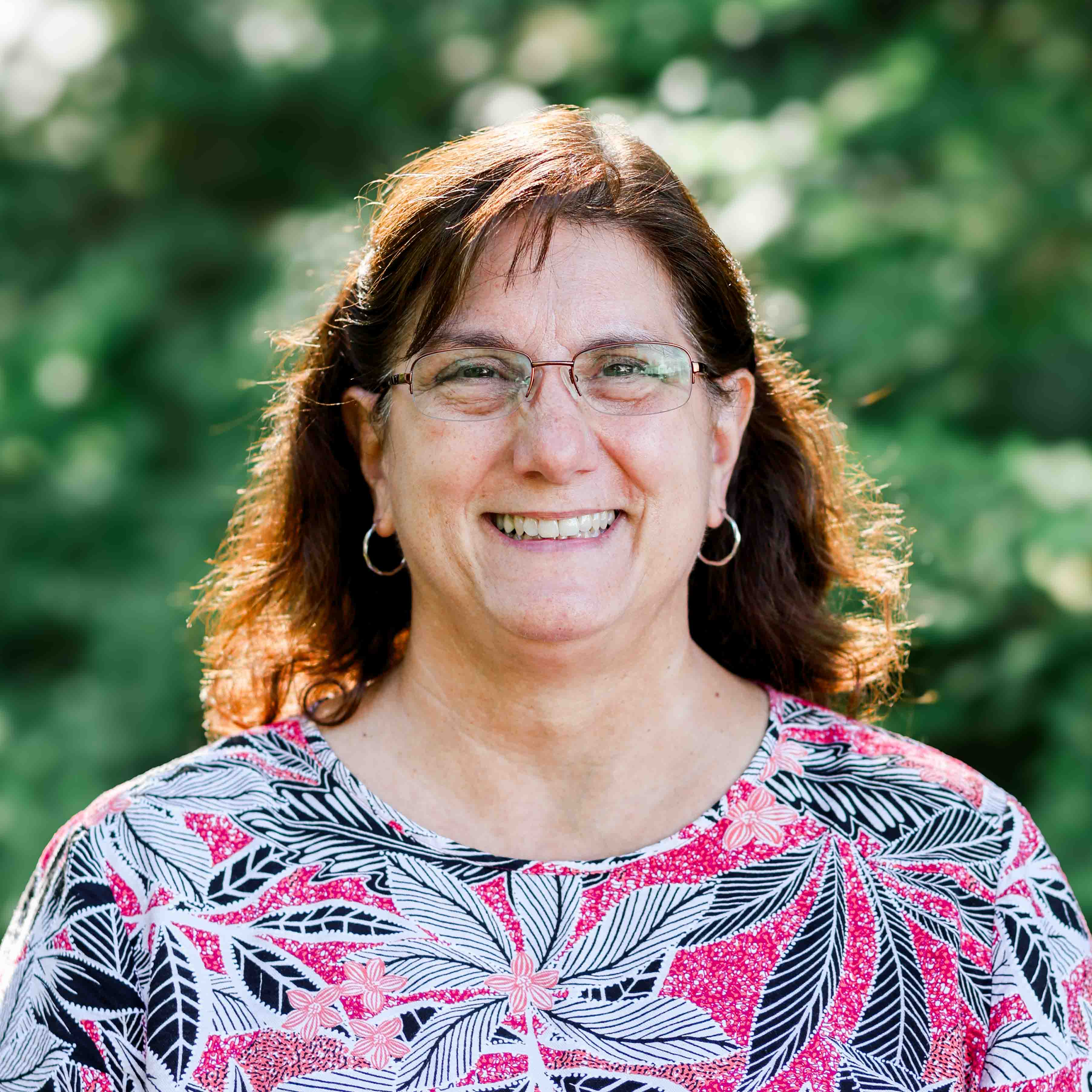 Outdoor headshot of Admissions Director and Office Manager, Nancy Fenter.