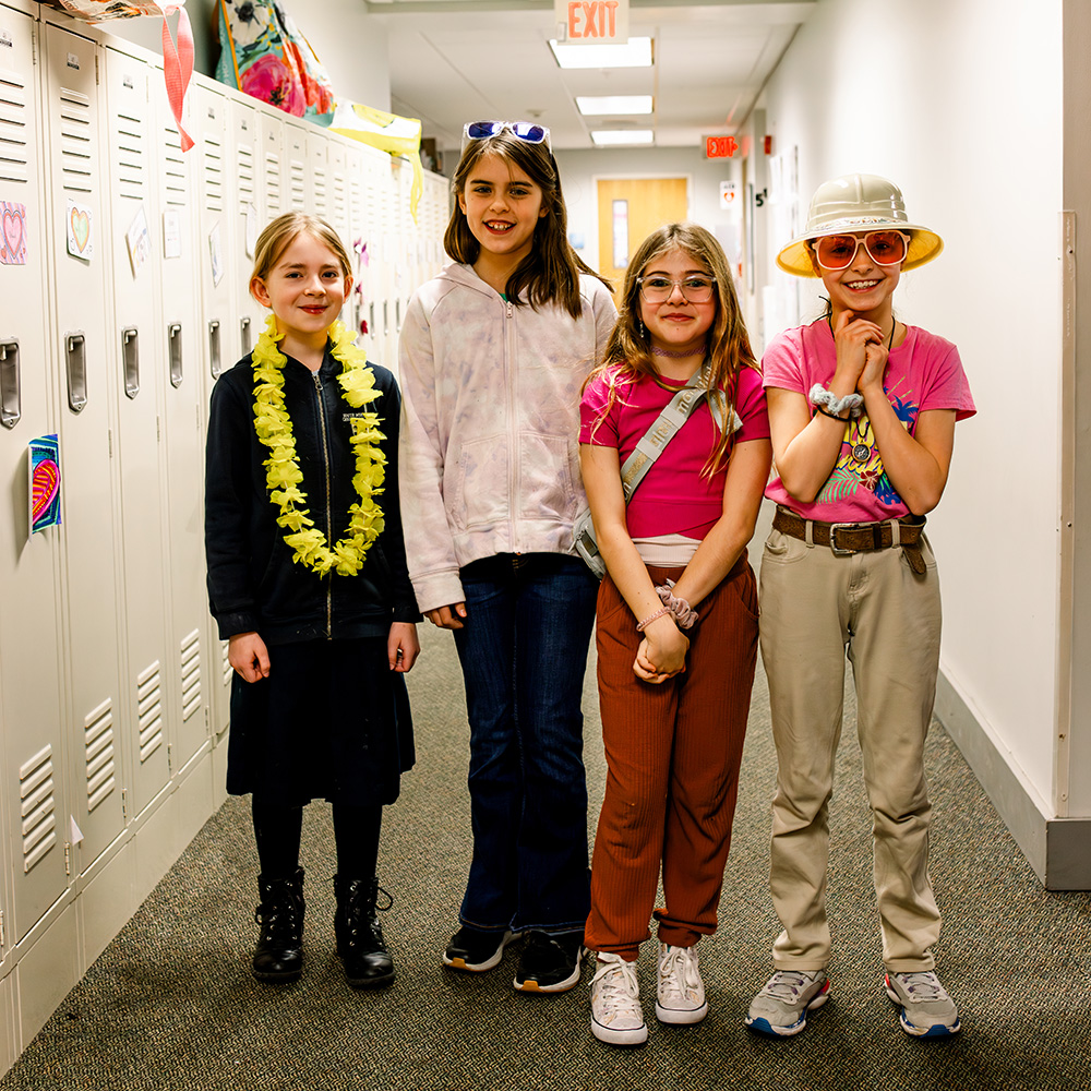 Four girls are dressed up as safari explorers for Spirit Week.
