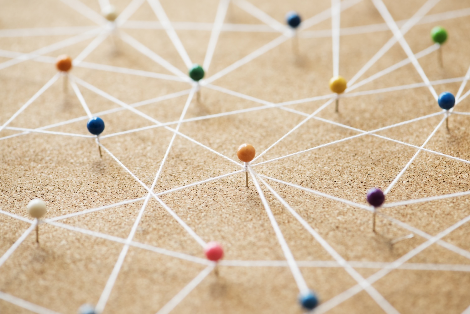 Push pins connected by lines forming a network