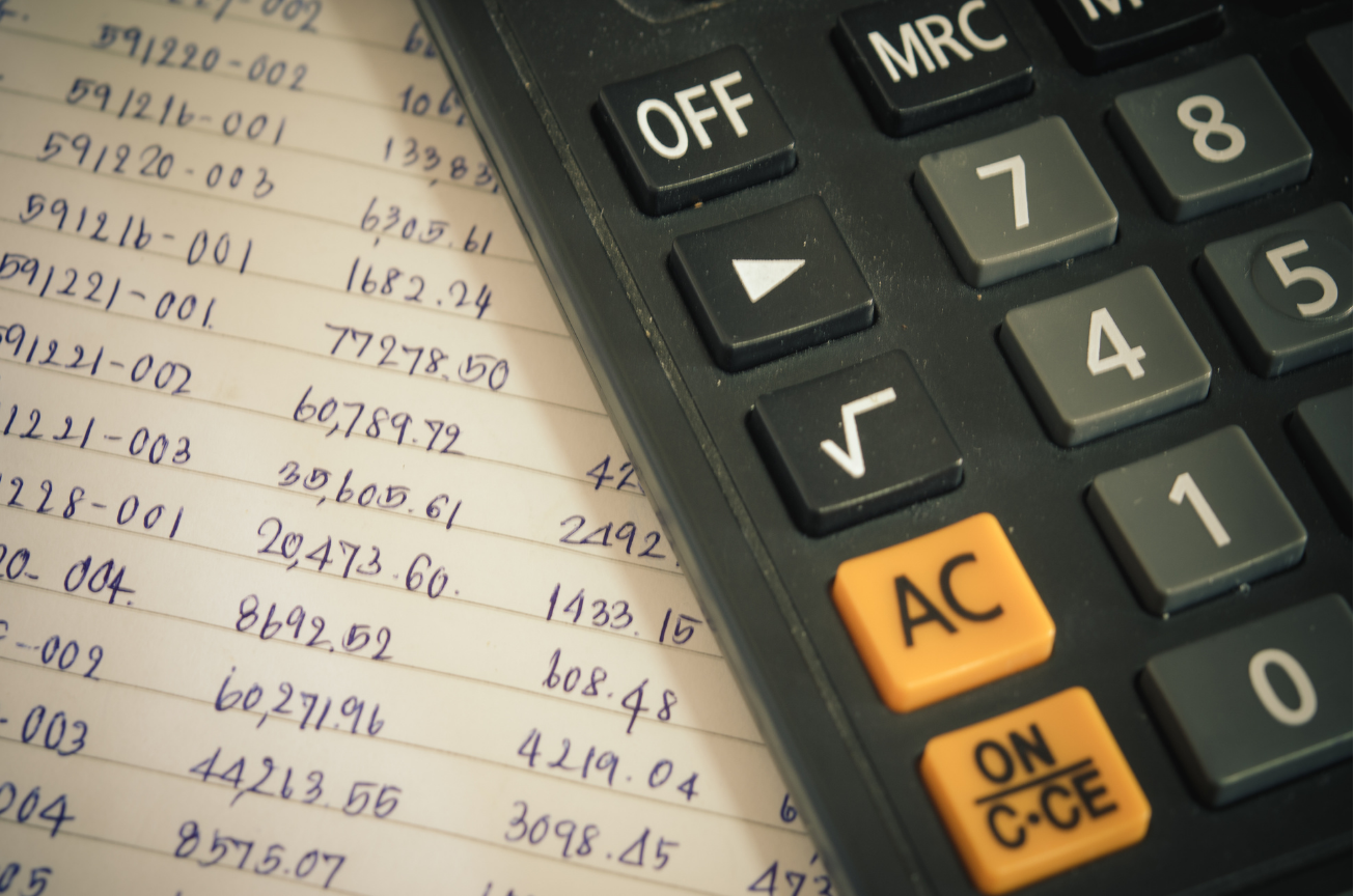 Calculator and handwritten pricing notes symbolizing the gap between smart bids and actual HVAC profitability.