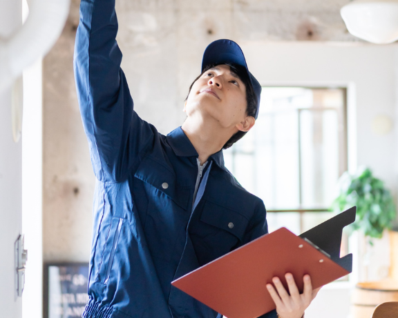 HVAC tech pointing toward ceiling during inspection, symbolizing strategic insight and missed growth potential.