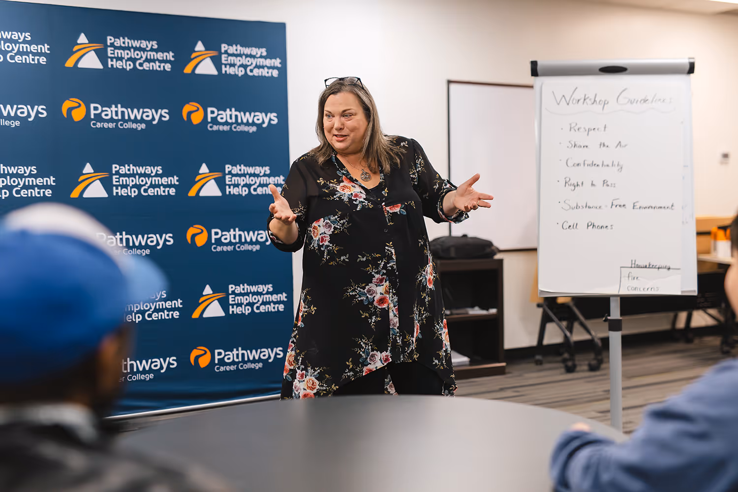 Pathways staff member speaking with participants during a workshop.