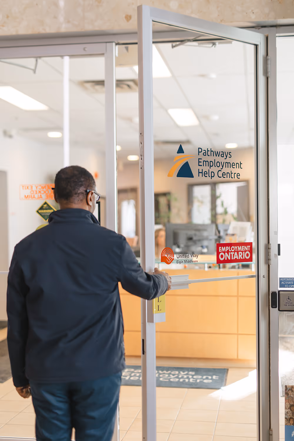 Pathways client opening door to walk into Pathways offices