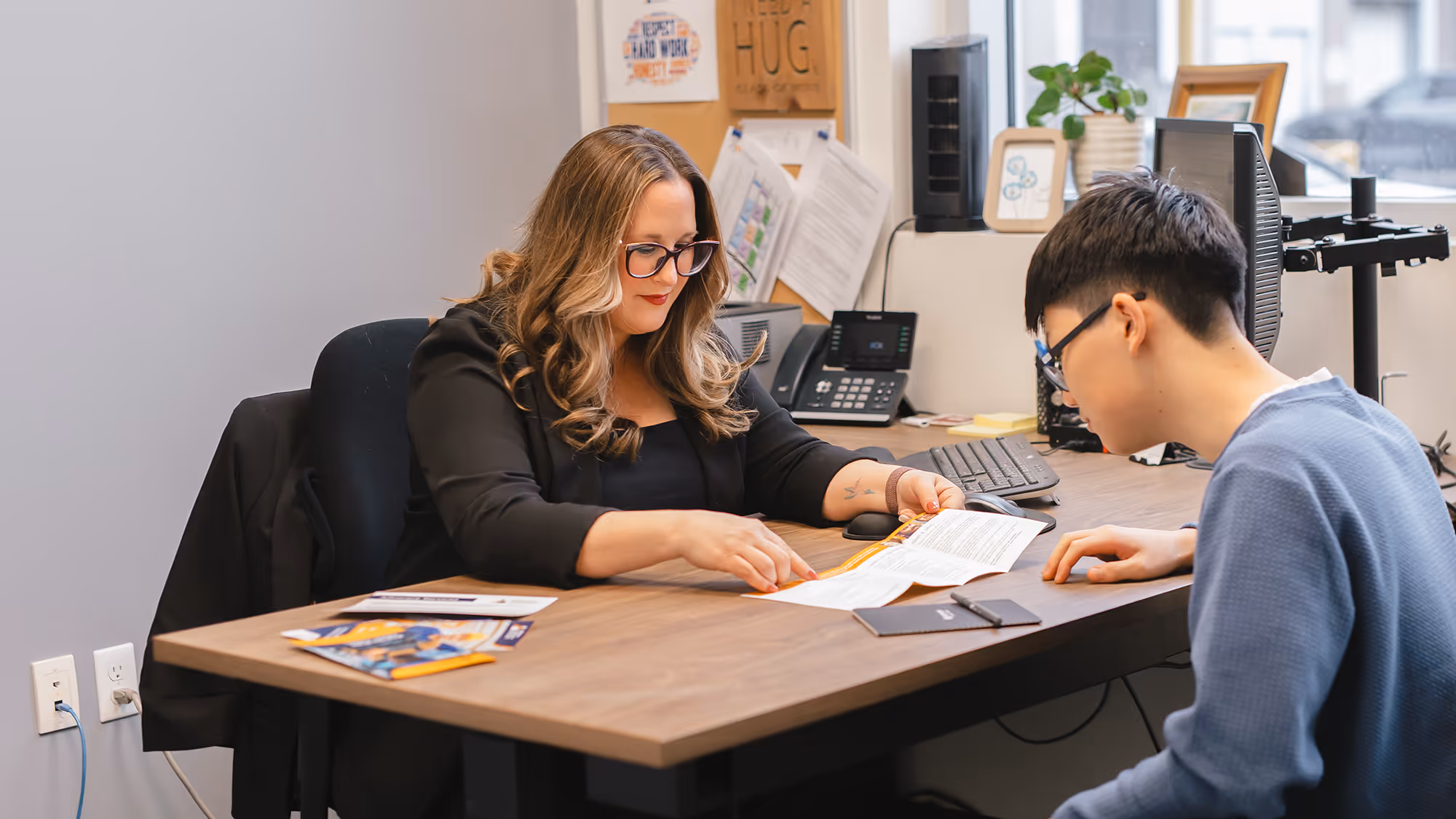 Pathways staff member looking at documents together with a Pathways client
