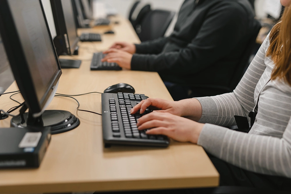 Close up of Pathways client typing on keyboard at computer