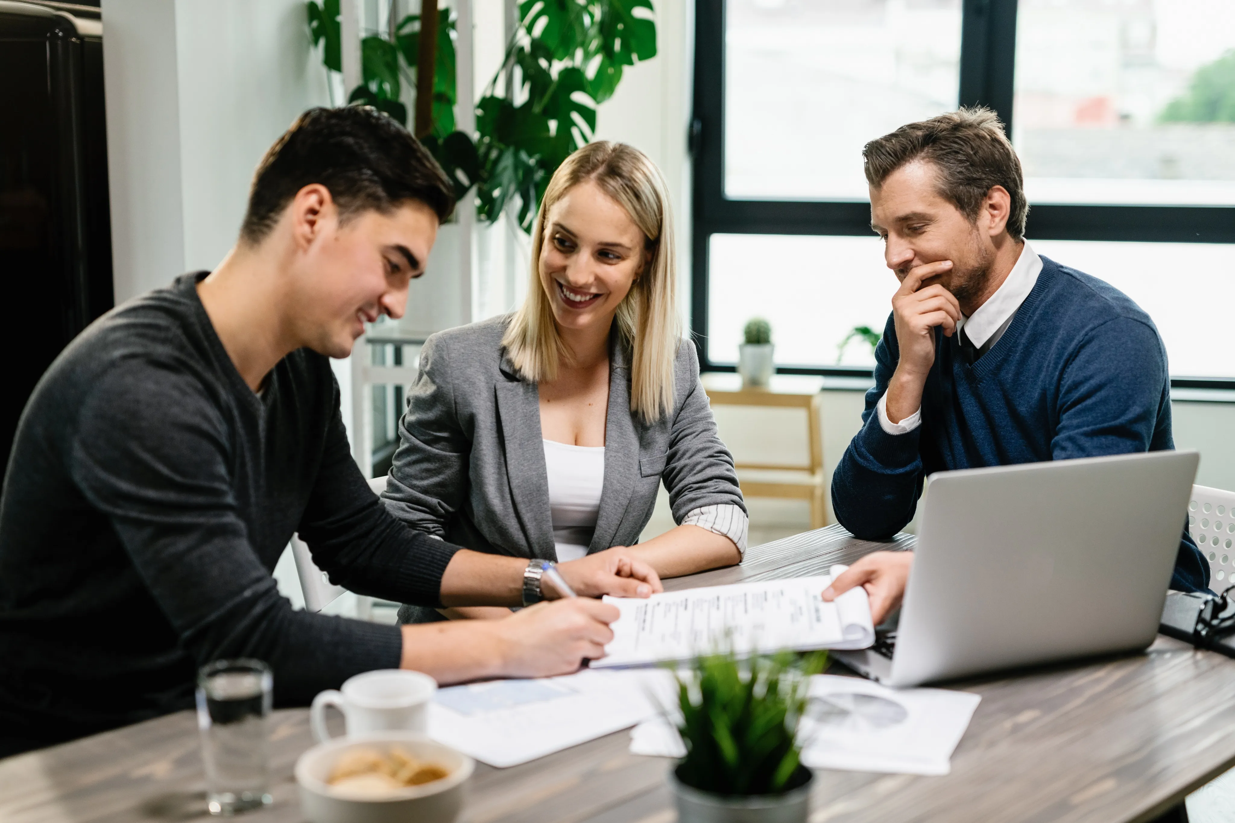 A couple finalizes insurance documents with an expert, illustrating the supportive process of working with an independent insurance agency in South Florida.