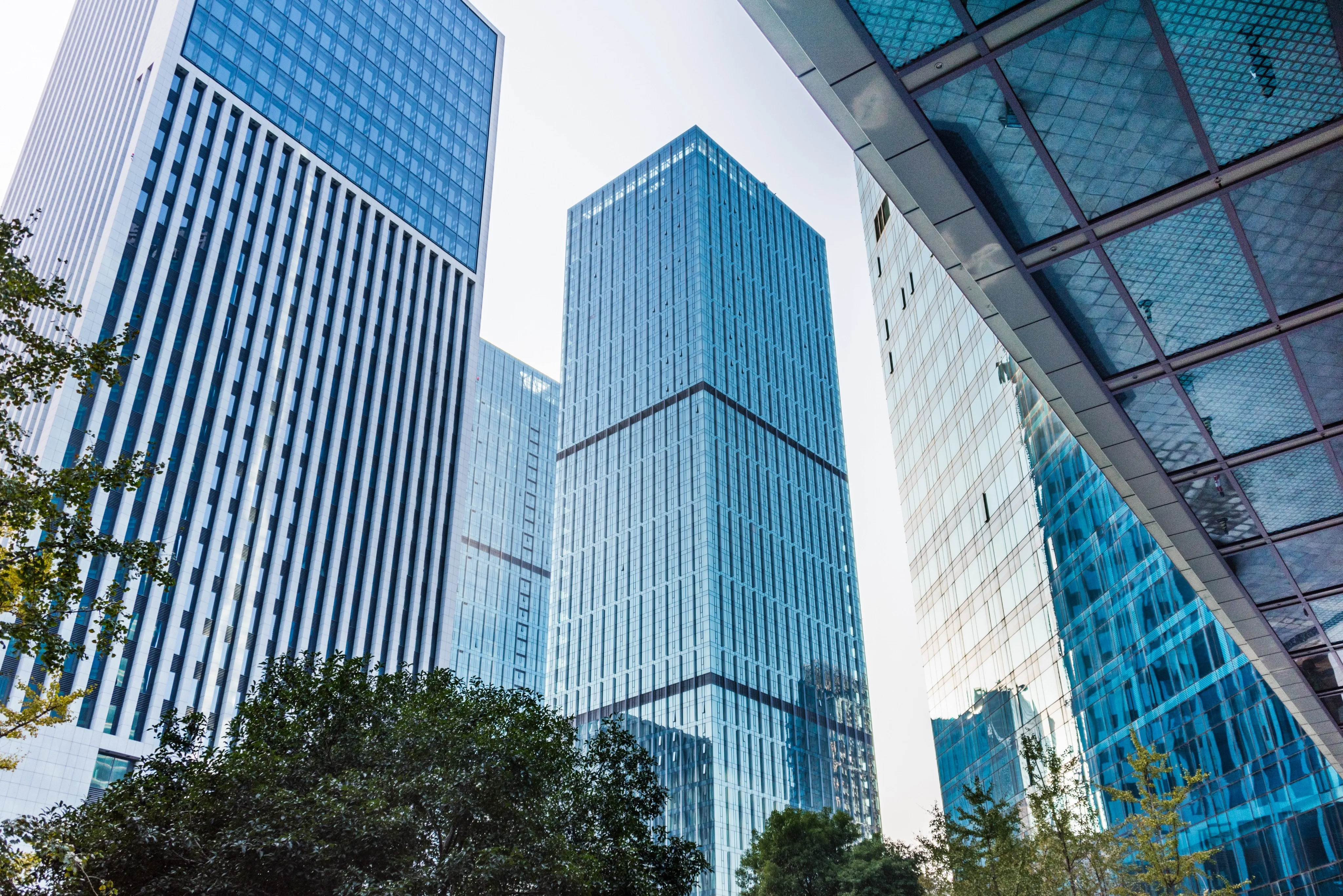 Tall modern glass skyscrapers, ideal for business property and equipment coverage.