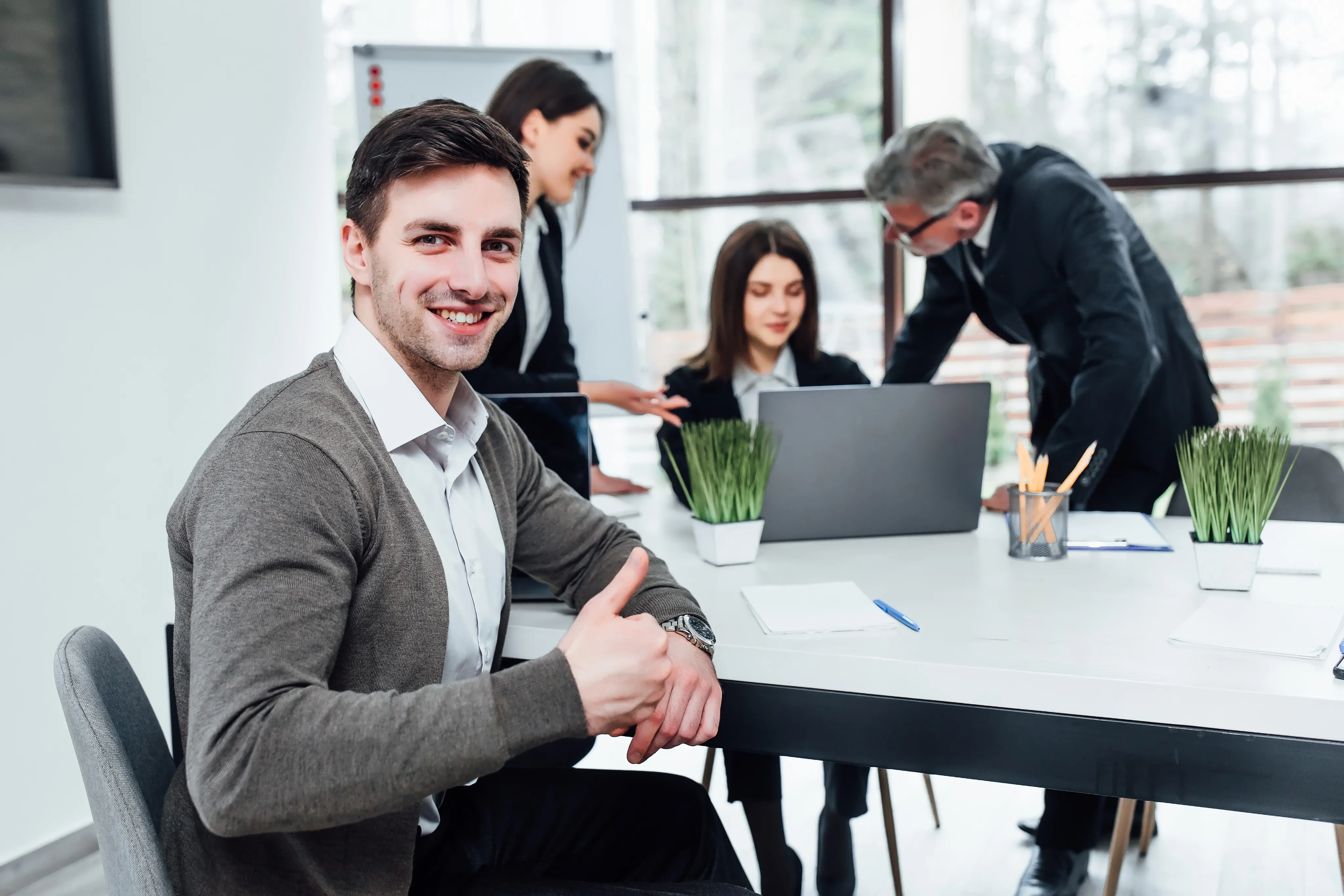 A man smiling while his wife is filling up insurance.