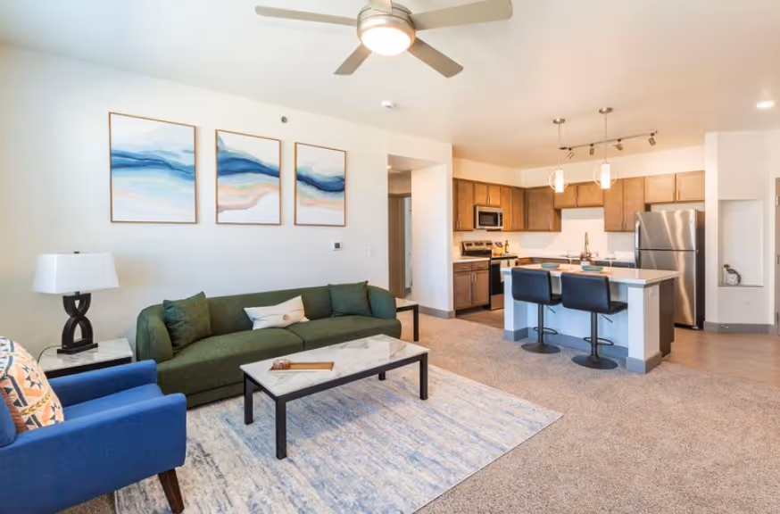 Modern apartment building exterior with blue and gray accents, featuring balconies and a contemporary design at Pueblo Springs in Pueblo West, CO.
