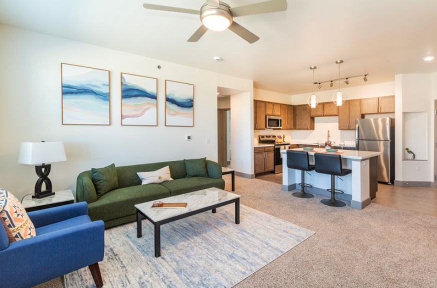 Modern apartment building exterior with blue and gray accents, featuring balconies and a contemporary design at Pueblo Springs in Pueblo West, CO.