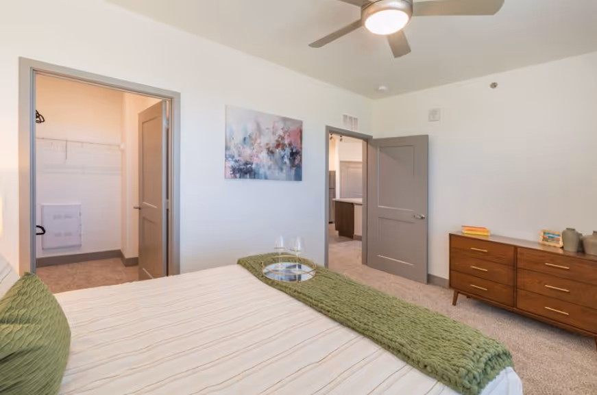 Gourmet community kitchen with a large island, wine fridge, stainless steel appliances, and sleek cabinetry at Pueblo Springs, Pueblo West, CO.