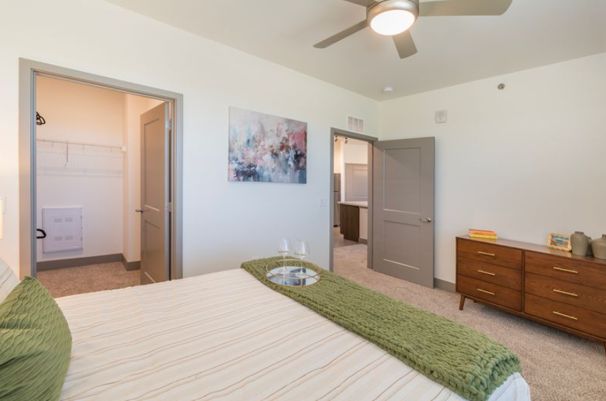 Gourmet community kitchen with a large island, wine fridge, stainless steel appliances, and sleek cabinetry at Pueblo Springs, Pueblo West, CO.