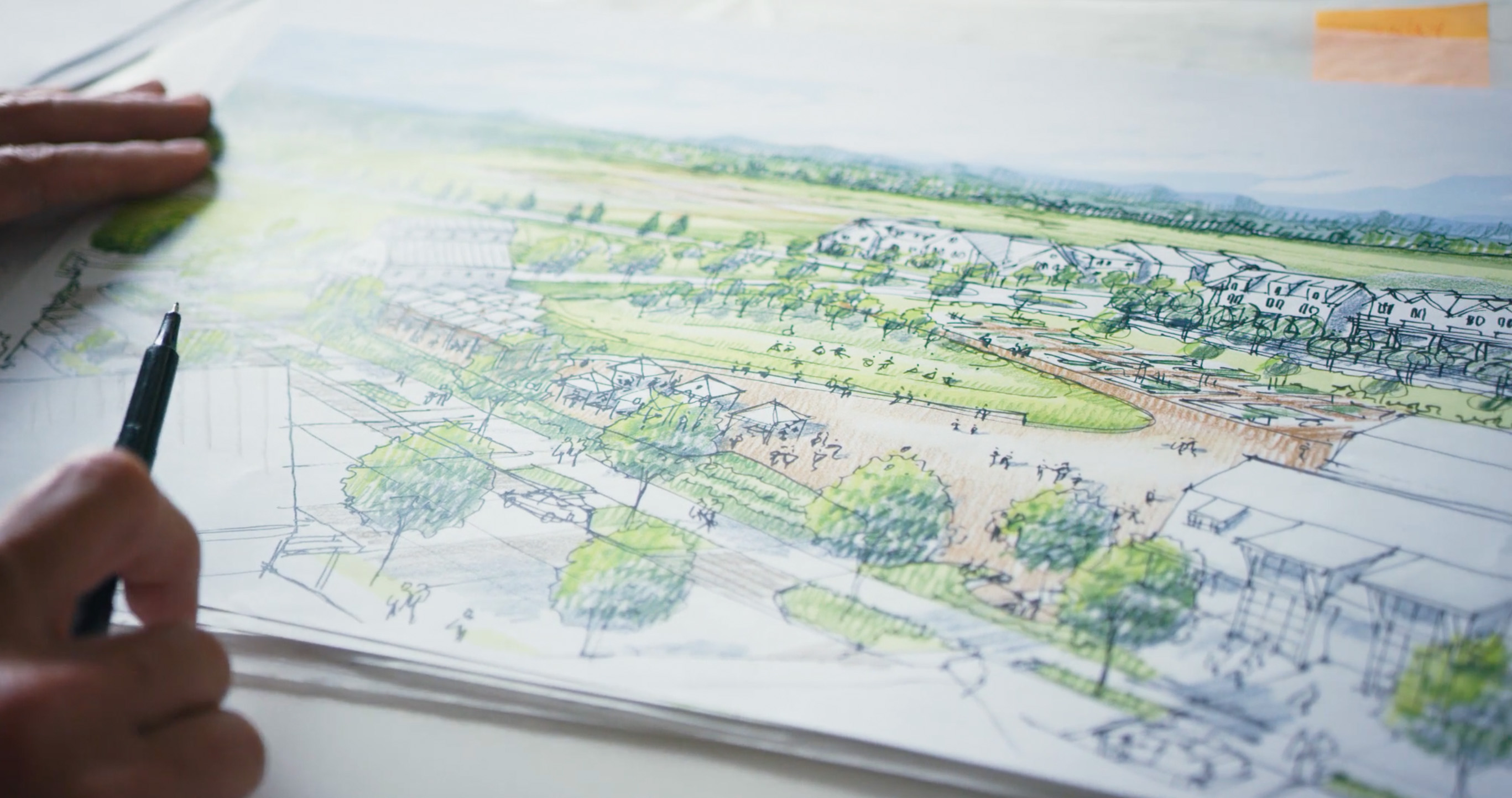 Hand sketching a community masterplan from a NoraVera development video