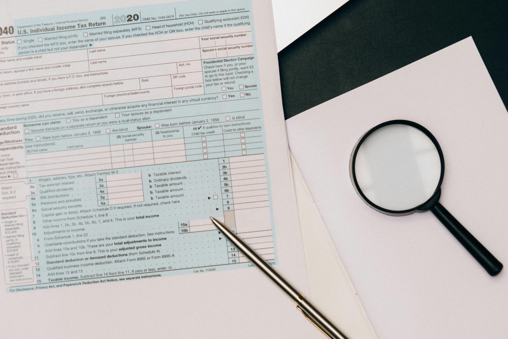 Magnifying glass, pen, and a 1040 tax form.|Comparison chart between 1099 Worker and Corp-to-Corp Workers (C2C) with aspects like tax structure, relationship type, risk to employer, benefits, and compliance burden.|Comparison chart between 1099 Worker and Corp-to-Corp Workers (C2C) with aspects like tax structure, relationship type, risk to employer, benefits, and compliance burden.