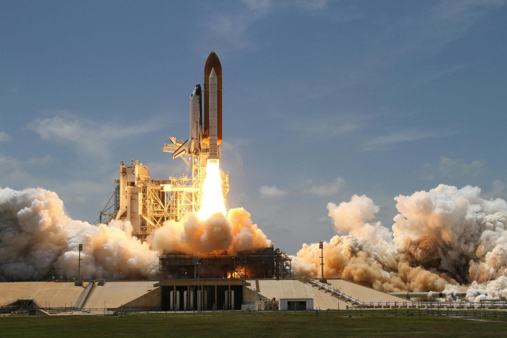 Space shuttle launching with flames and smoke.