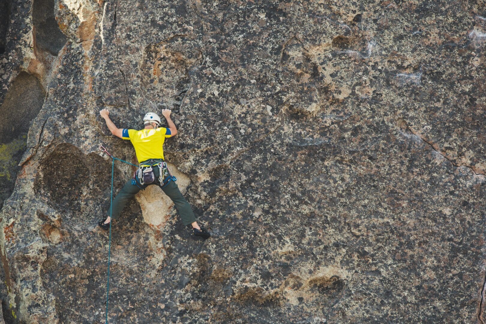 Person rock climbing on a steep cliff.