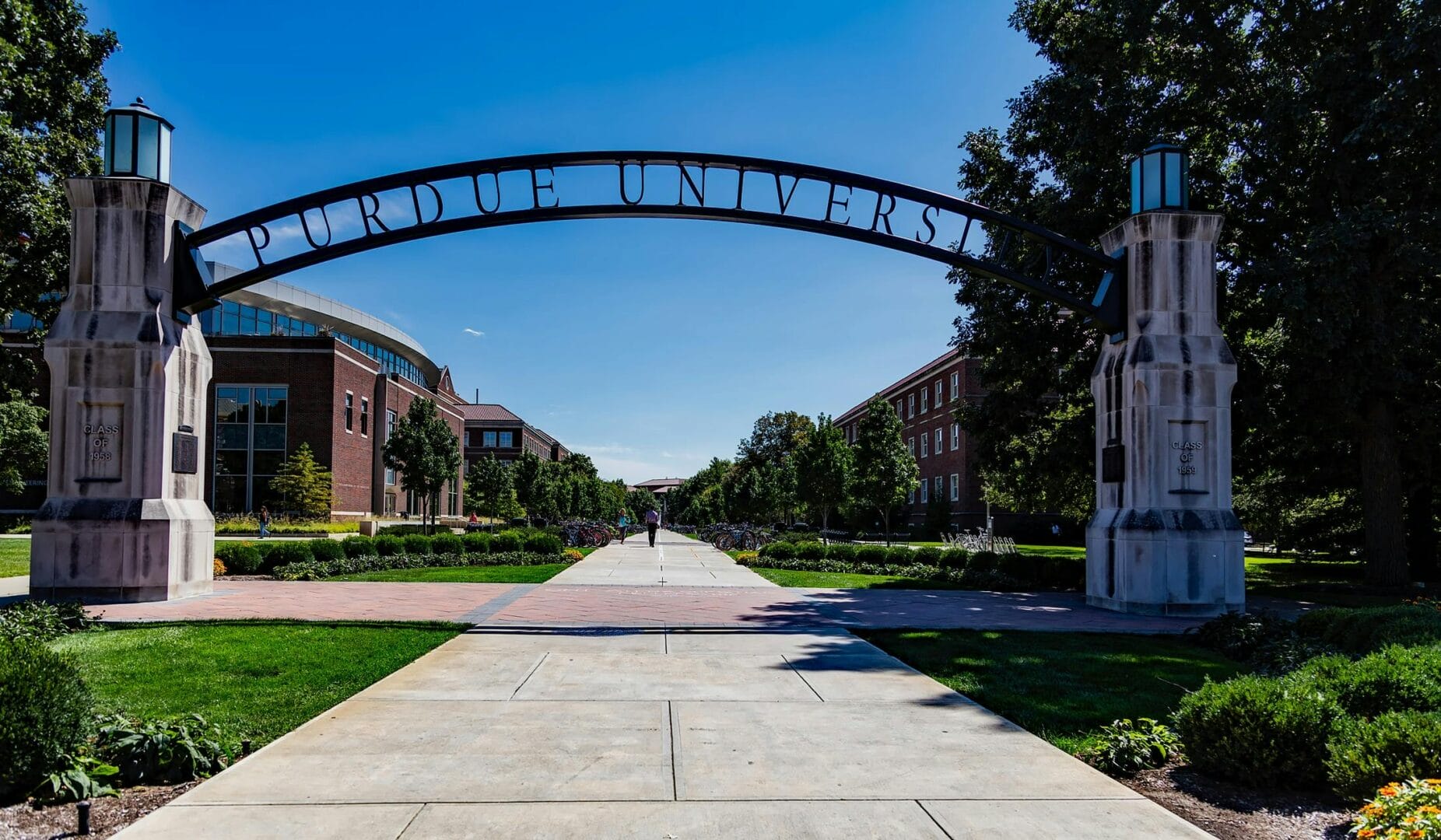 University entrance with a large archway and a pathway leading to buildings.