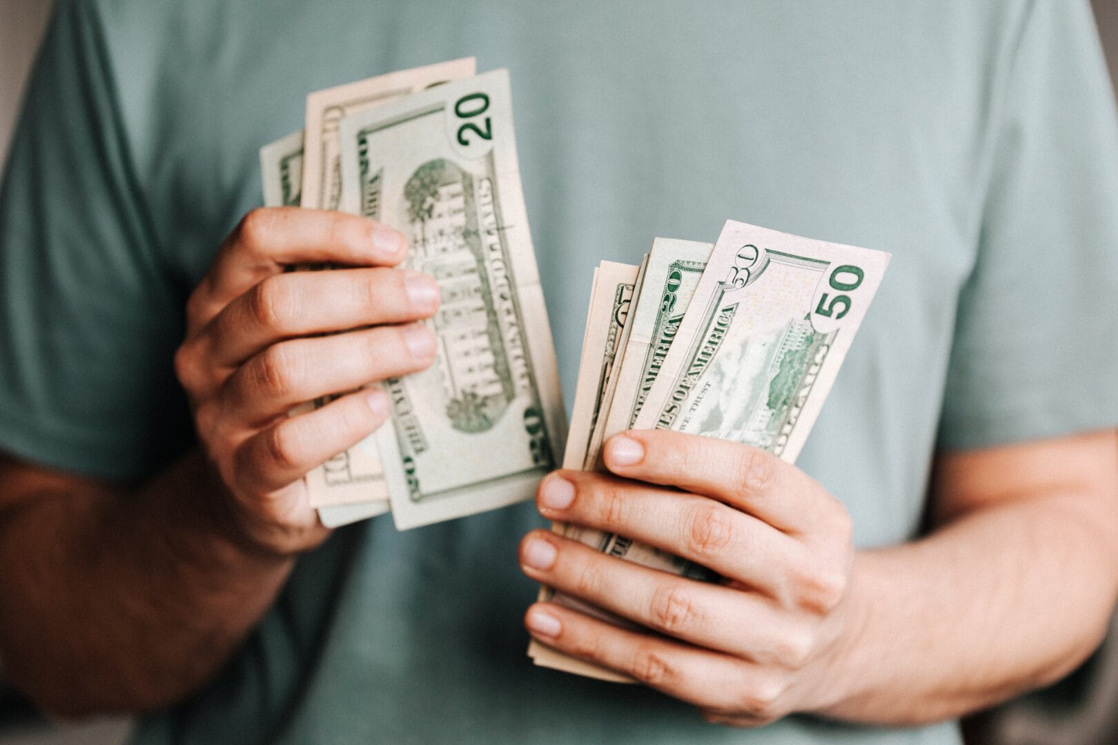 Close-up of a person holding money with a partially transparent overlay.