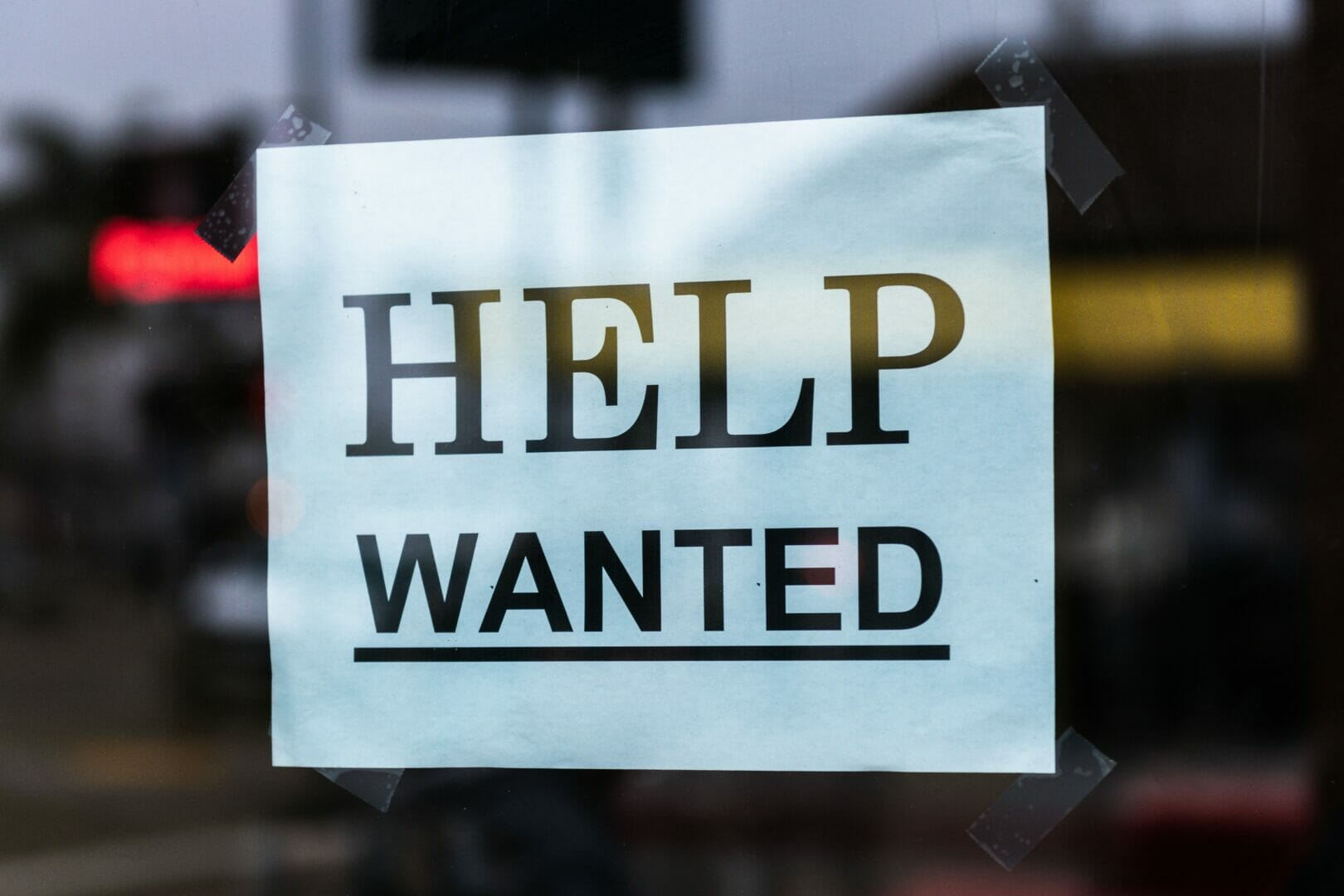 HELP WANTED sign on a window