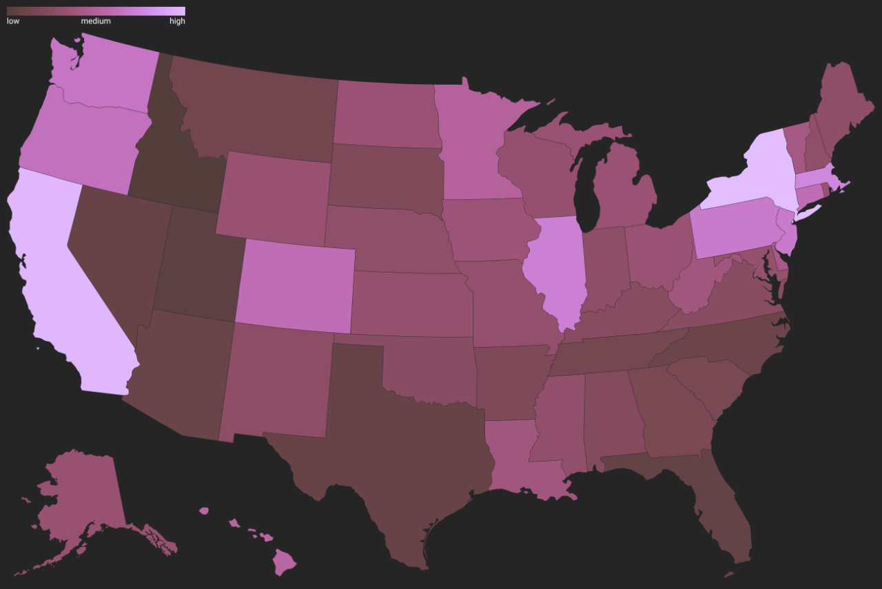 Office with a single worker among empty desks, representing slowed hiring in high-compliance states