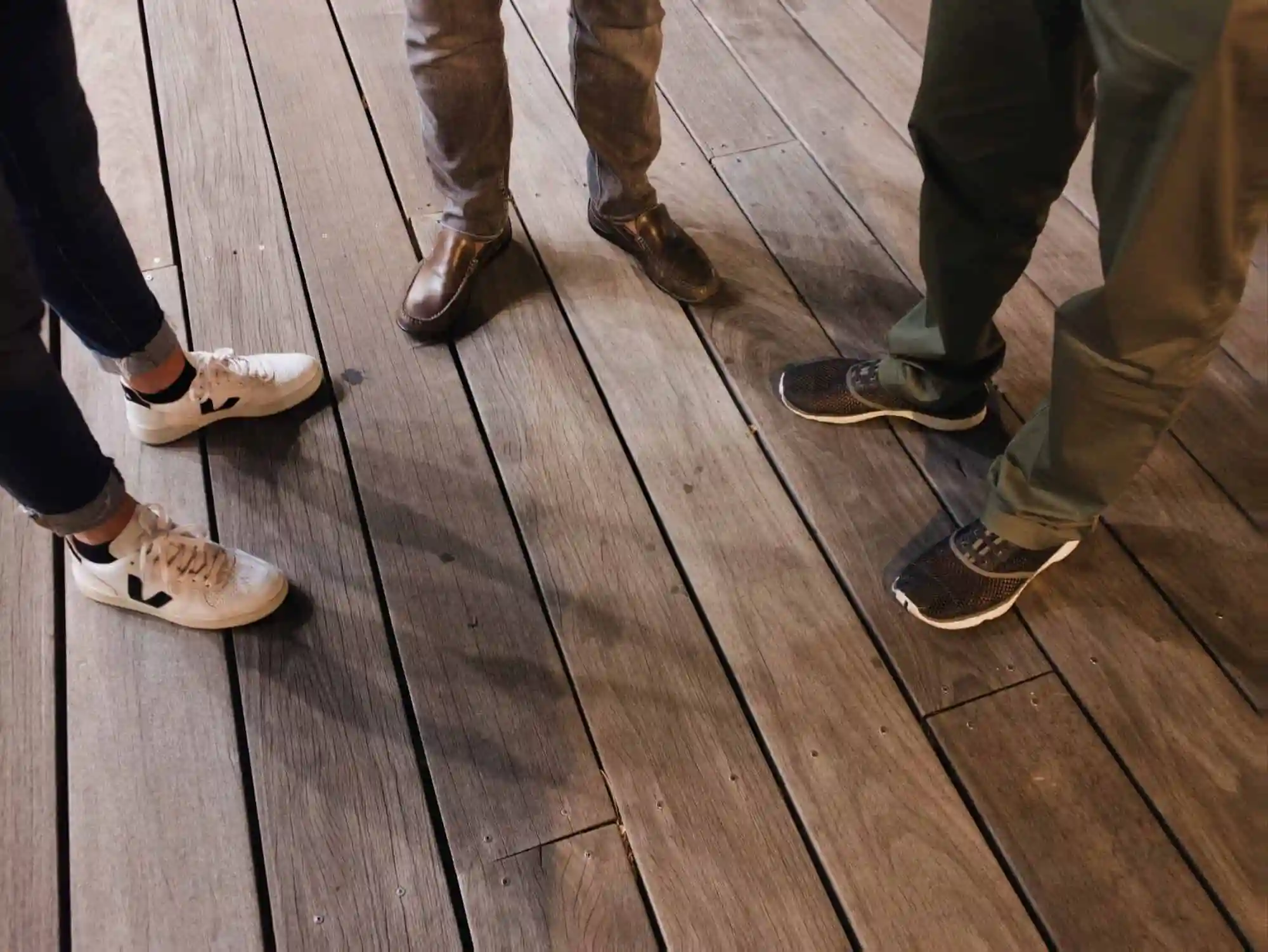 people standing on dark hardwood