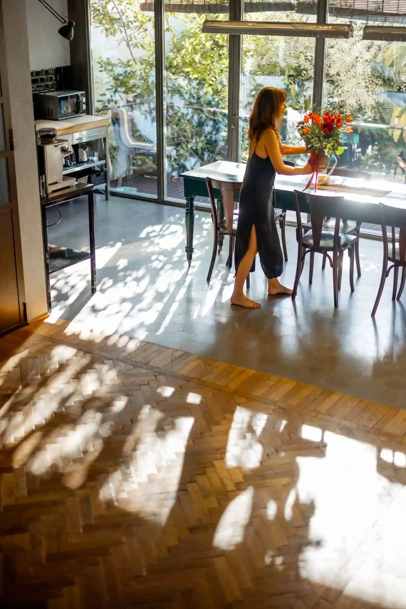 woman walking in sunlight in modern living room hardwood floors
