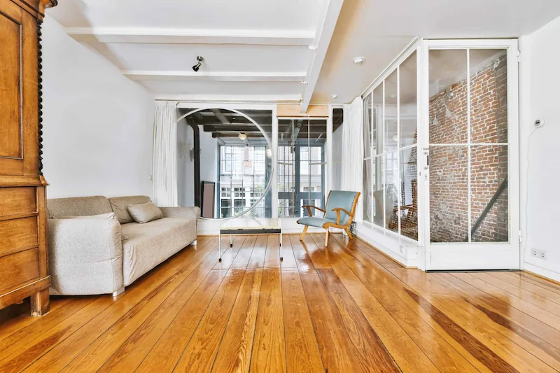 brightly lit living room on medium dark hardwood floor