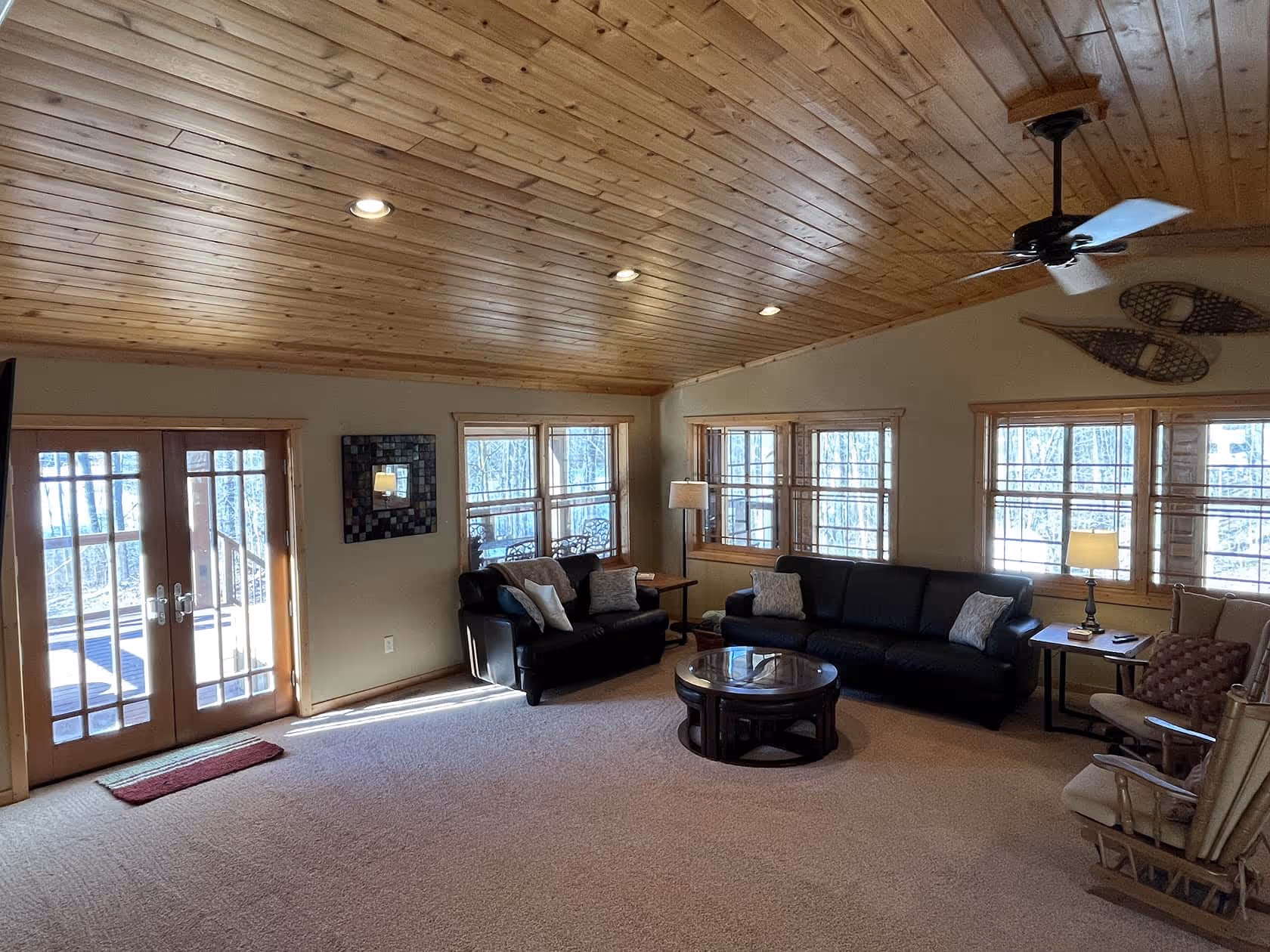 living room showing couches and windows