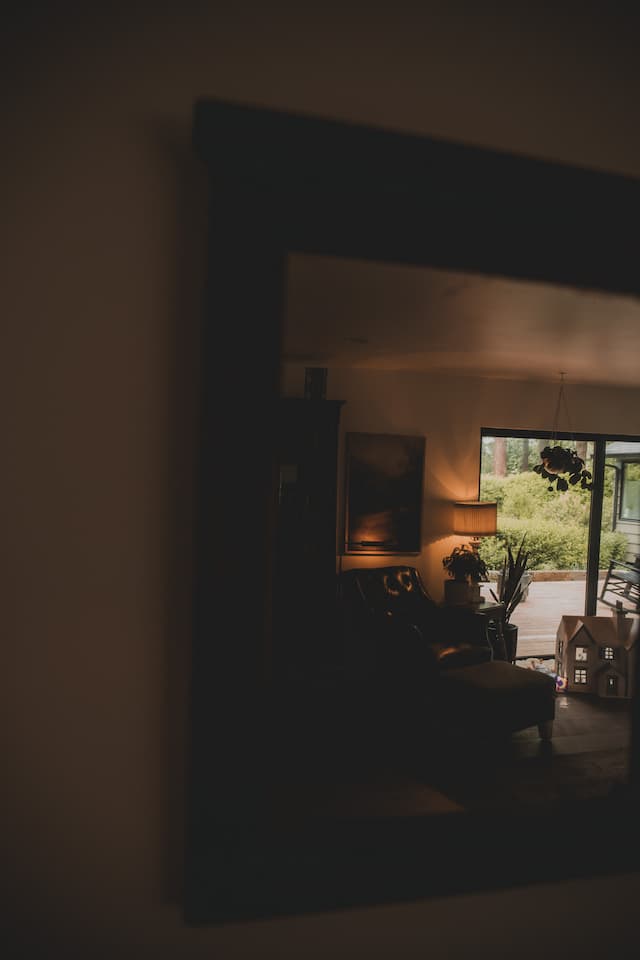 Reflection of a living space in a large wall mirror.
