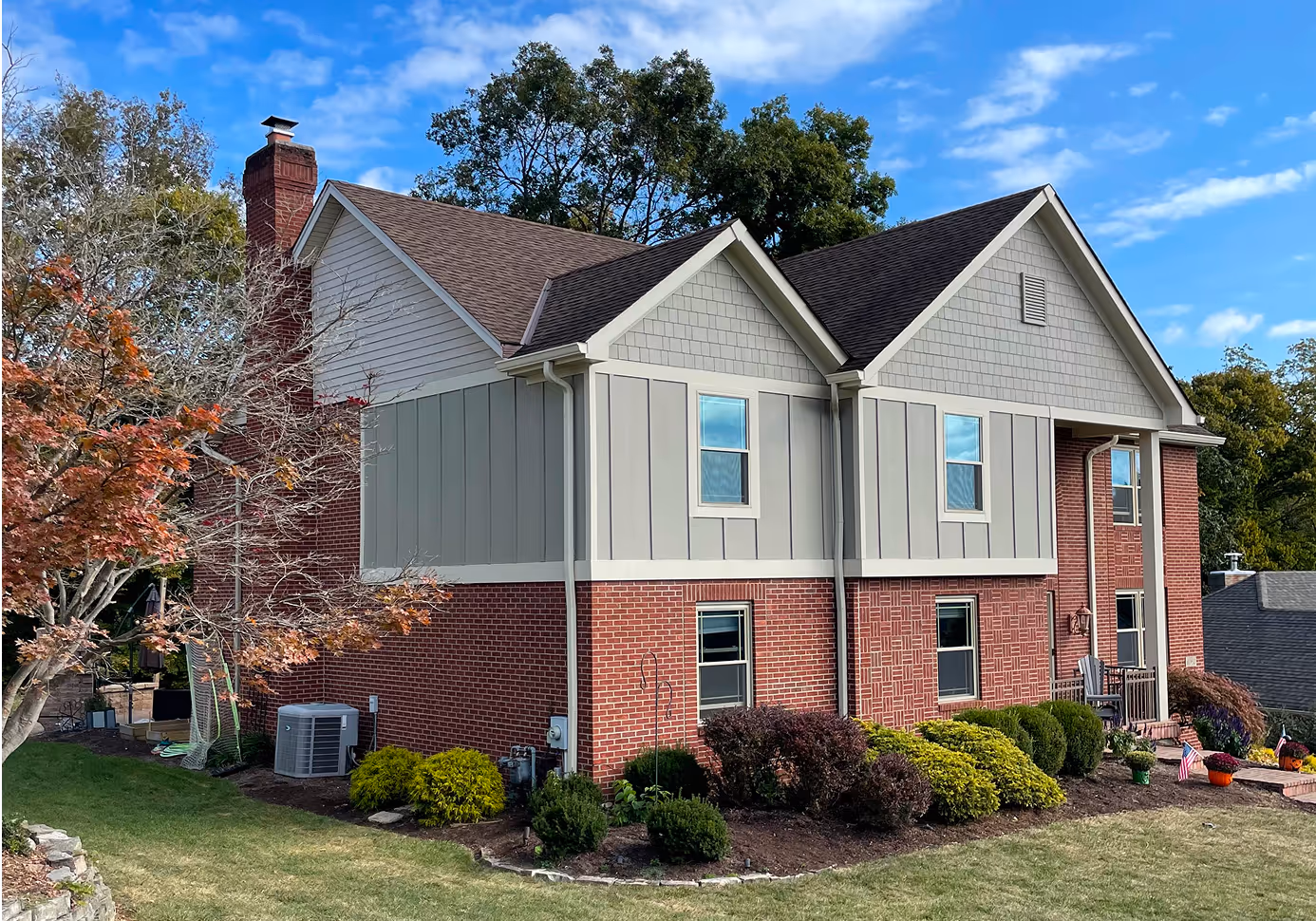 side of brick and grey house