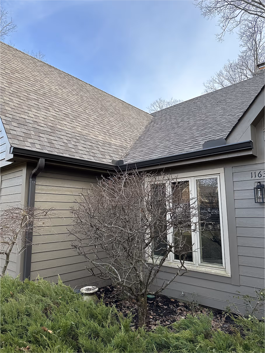front side of grey house with windows