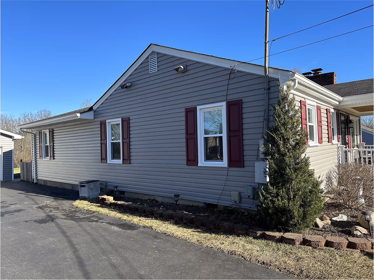 Side of grey house with windows