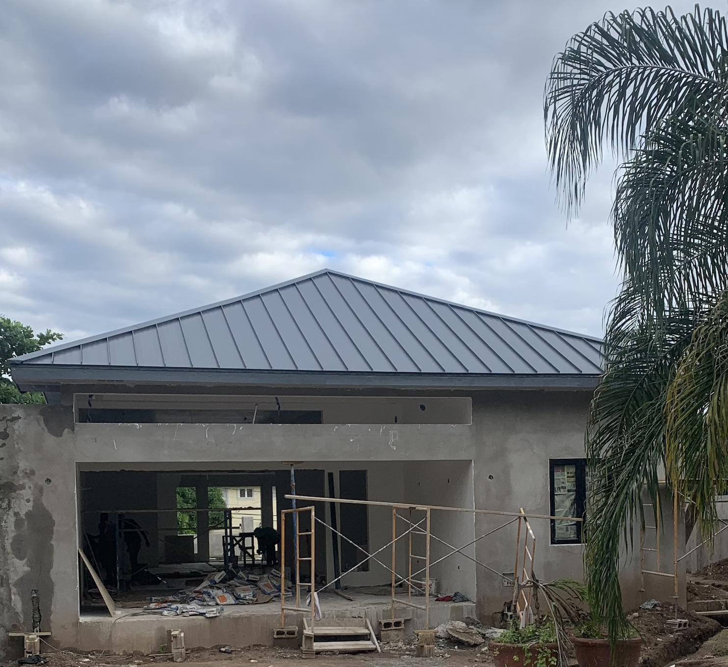 Modern standing seam metal roof installation on a residential home in Jamaica completed by Marcore Construction a roofing construction company in Jamaica