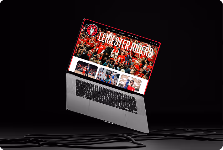 Open laptop displaying Leicester Riders basketball team website with fans and players.