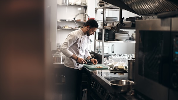 A chef dressed in a white coat working in a kitchen.
@novokayn on Instagram