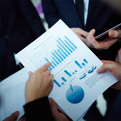 a person holding paper with chart information