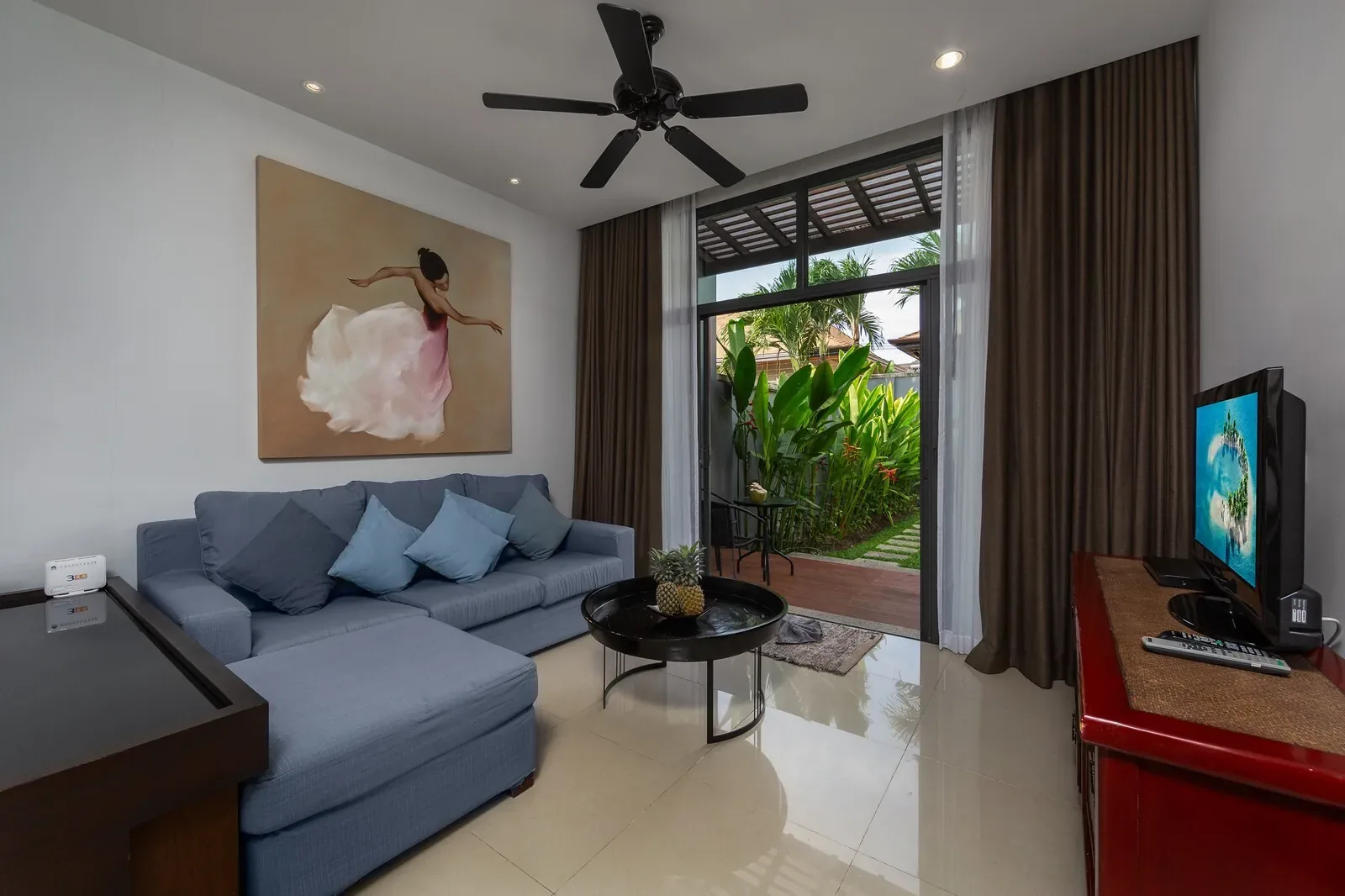 Villa Java, Най Харн — гостиная с голубым диваном и телевизором