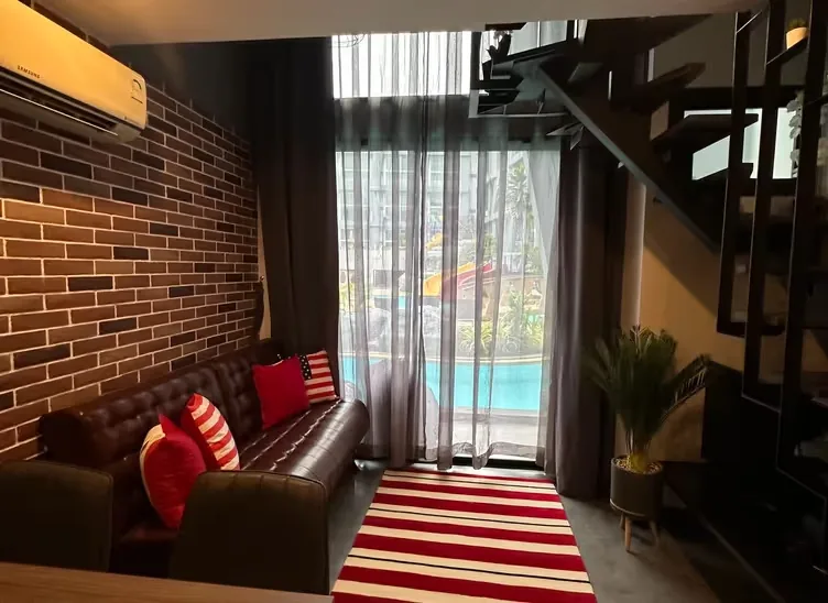 Living room with sofa and stairs to the upper level — Utopia Nai Harn, Nai Harn