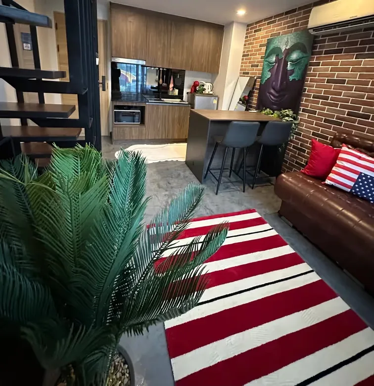 Living room with bar stools and striped rug — Utopia Nai Harn, Nai Harn