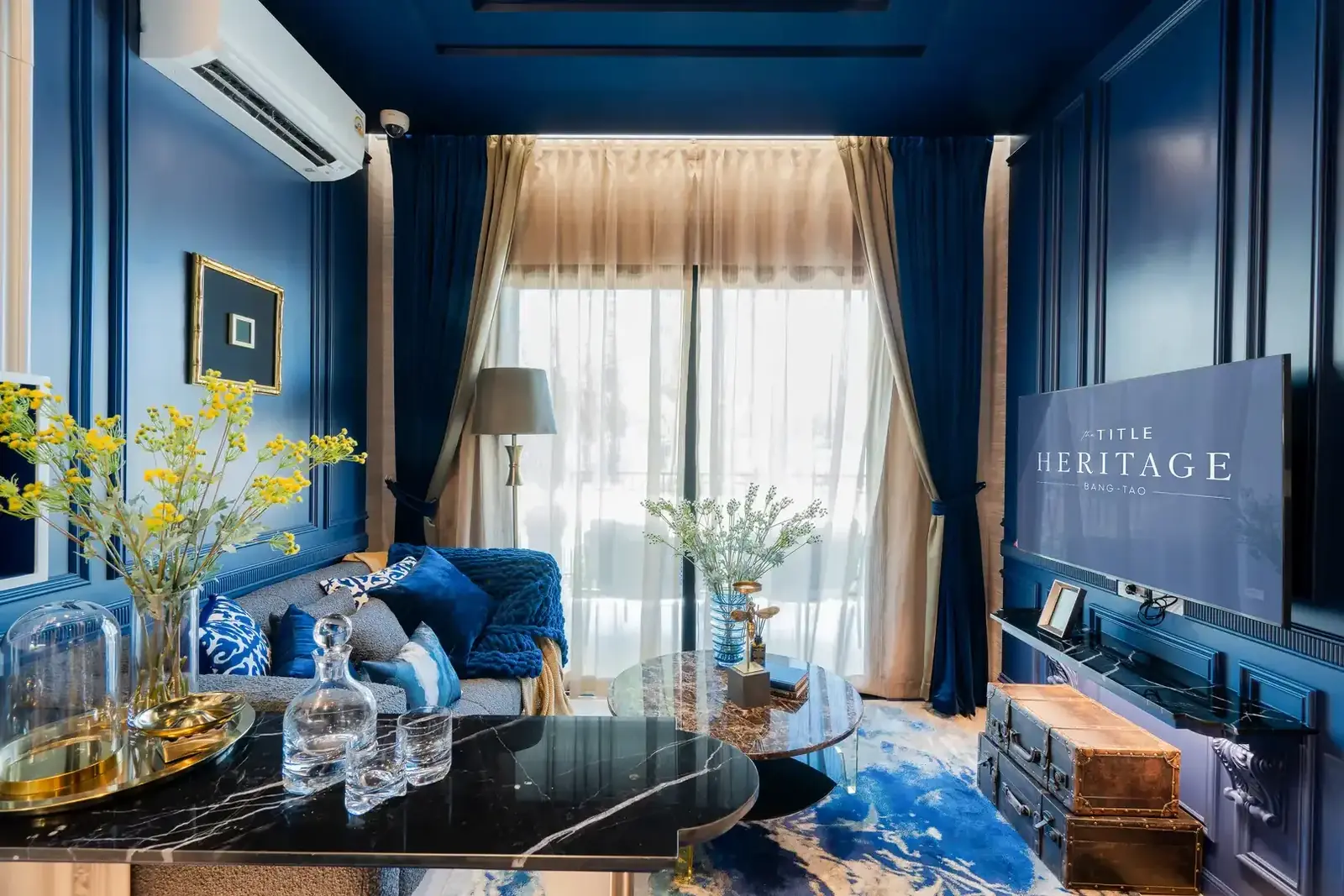 Living room with TV and blue walls — The Title Heritage, Bang Tao