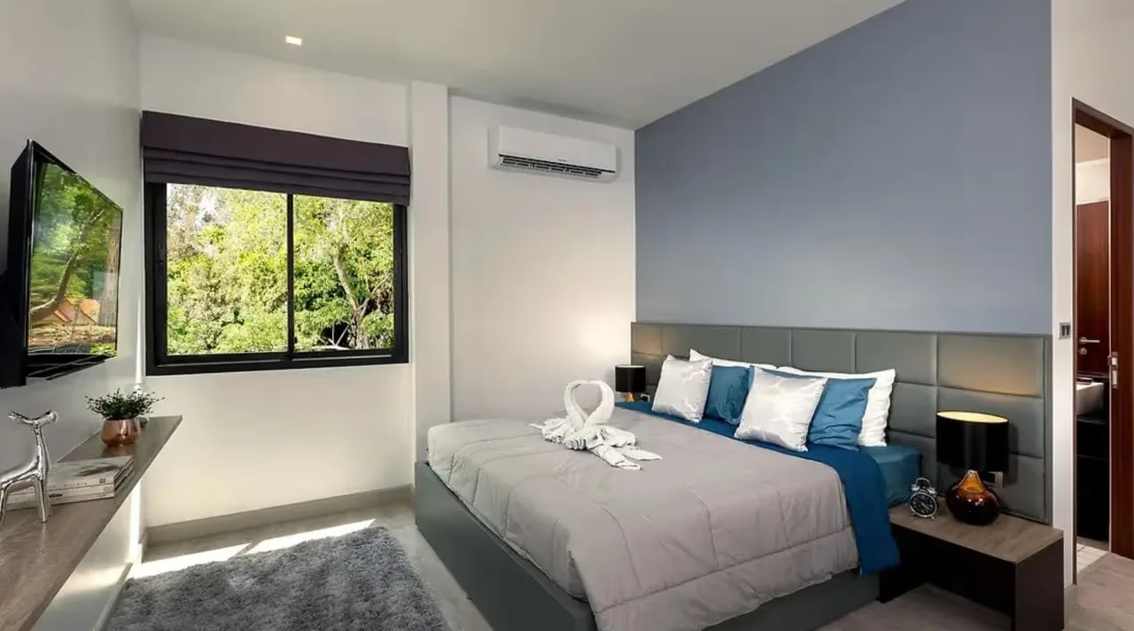 Bedroom with TV and a window onto the garden — Utopia Nai Harn, Nai Harn