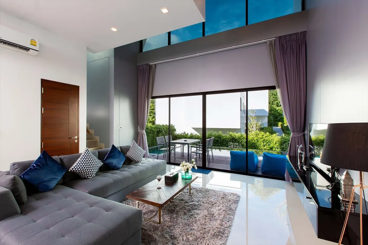 Living room with sofa and pool access — Utopia Nai Harn, Nai Harn