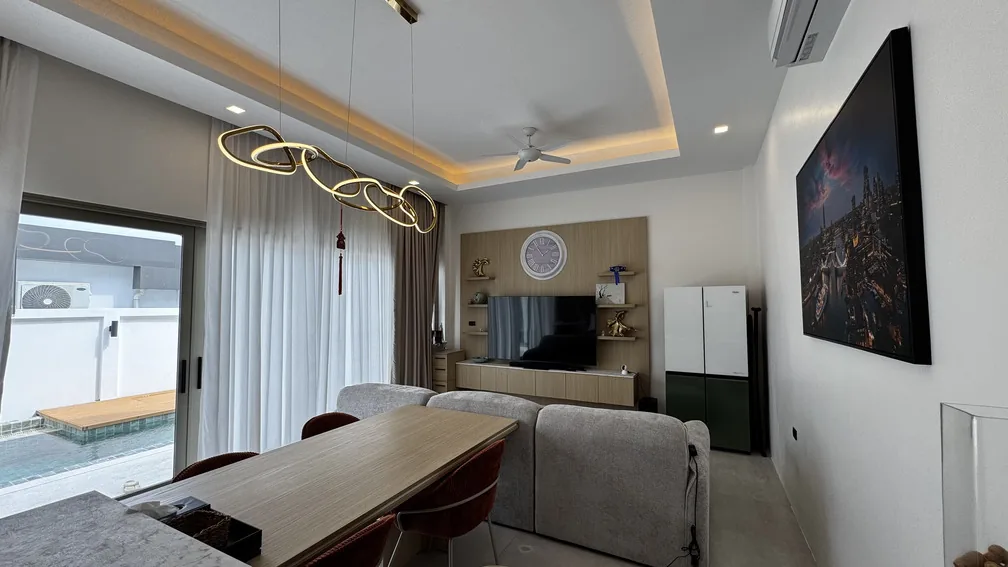 Living room with dining table and pool access — Ban Bua, Nai Harn