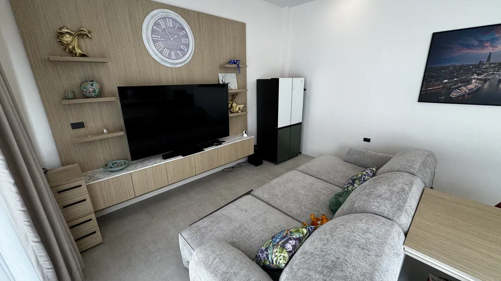 Living room with corner sofa and wall-mounted TV — Ban Bua, Nai Harn