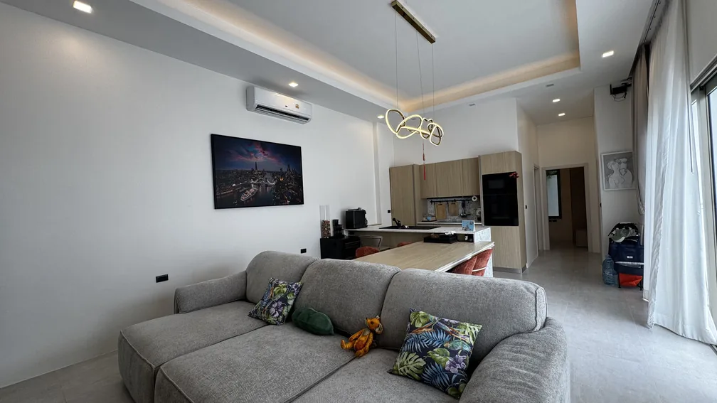 Living room with sofa and kitchen beyond — Ban Bua, Nai Harn