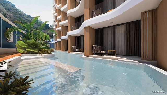 Бассейн вдоль корпуса с балконами на фоне холма — Vibe Residence Karon, Карон
