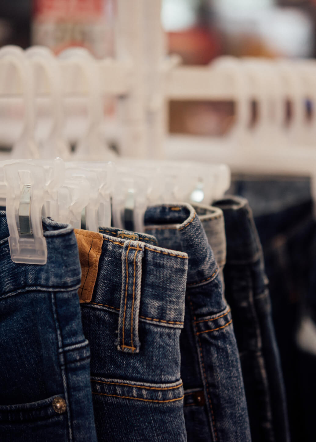 jeans hanging on a rack in a store