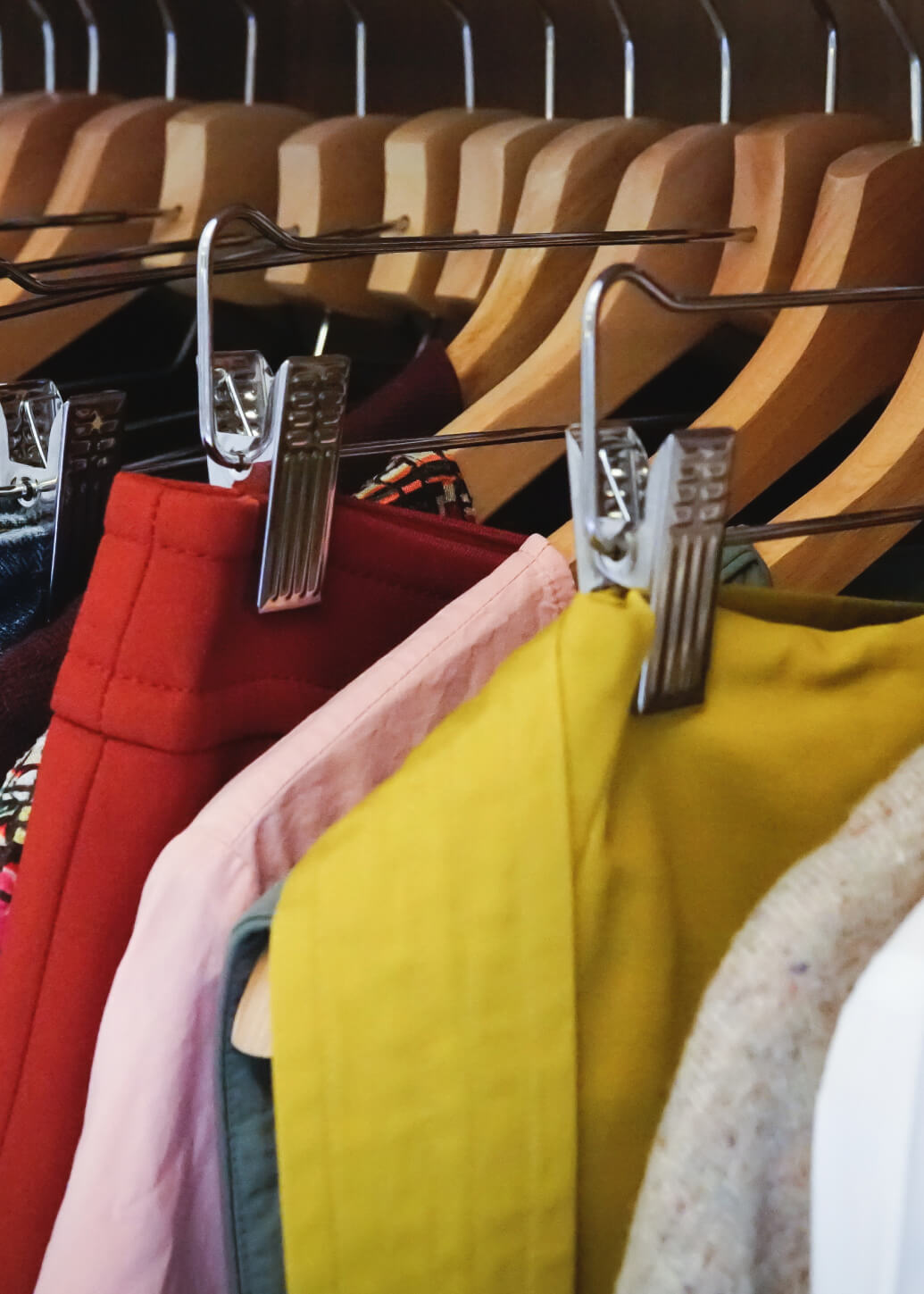 a row of clothes hanging on a rack